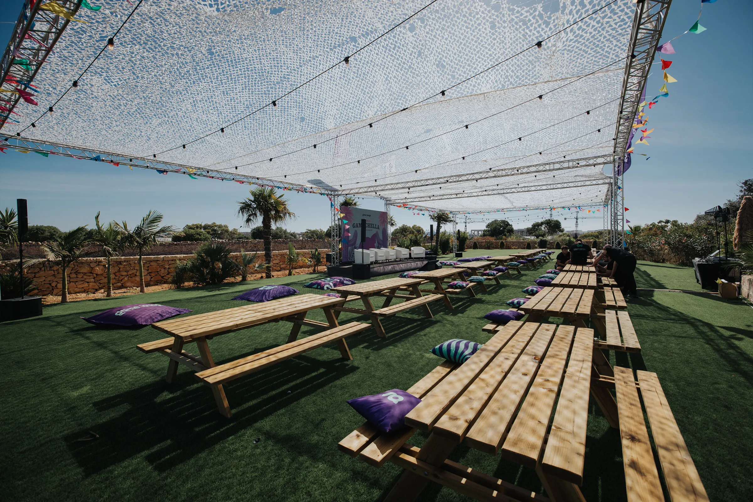 Guests gathered beside the pool at the Game Lounge summer celebration in Malta.