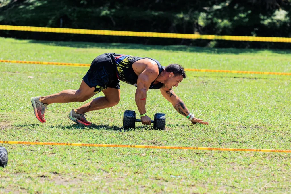 An athlete completing an outdoor dumbbell challenge