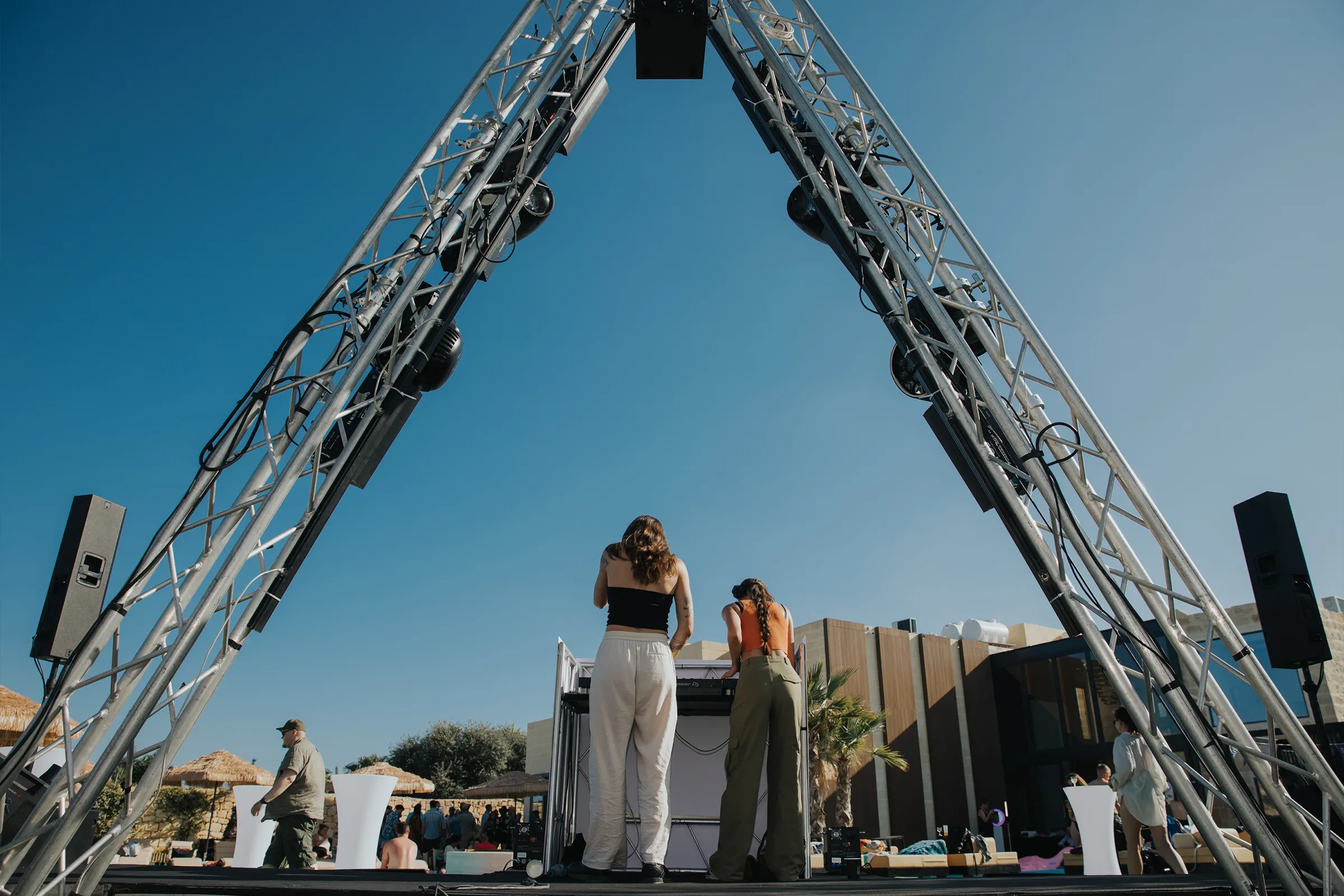 Guests and live performers at the Game Lounge celebration, with dining tables, event branding and production around the room.