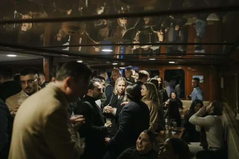 Guests chatting inside the boat · AFLOAT — Exclusive Networking at Sea