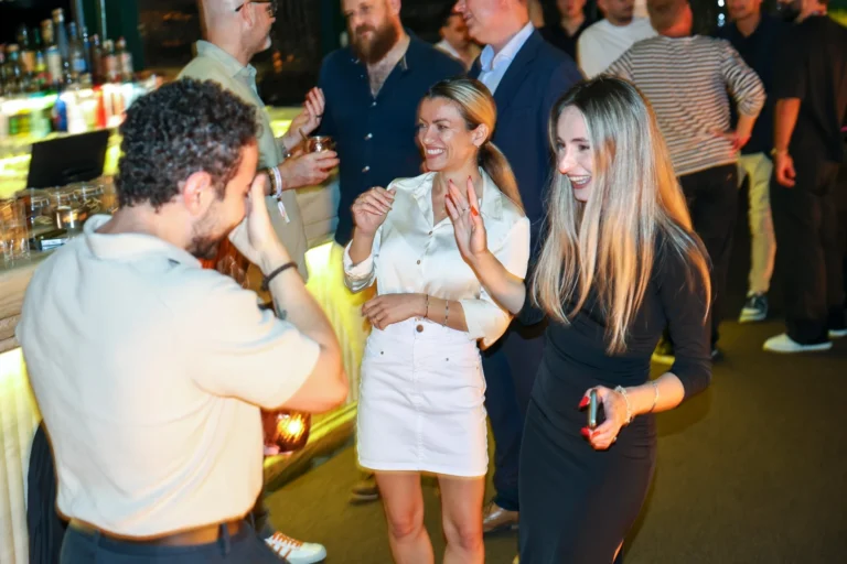 Guests chatting and laughing at Altitude × EveryMatrix in Lisbon.