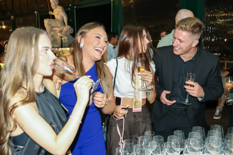 Guests sharing a laugh and drinks at Altitude Lisbon 2026.
