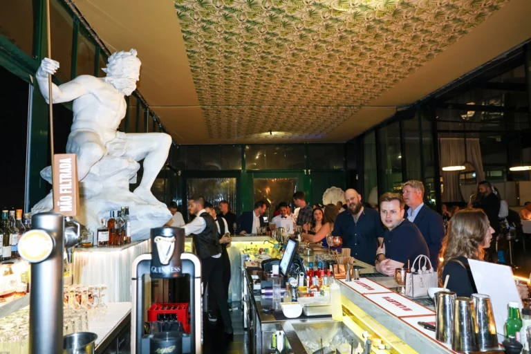 Guests gathered beside the bar at ÀCosta by Olivier during Altitude Lisbon 2026.