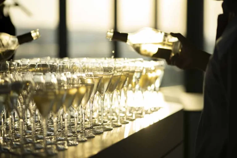 Champagne glasses at sunset · Above the island