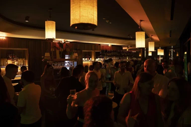 The rooftop lounge filled with guests · Above the island